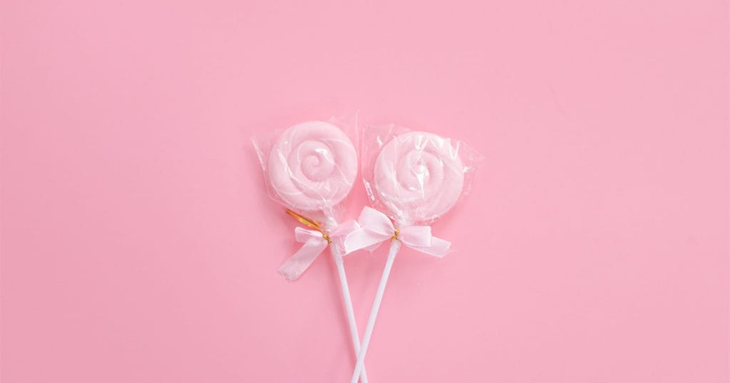 Two Pink Lollypops on Pink Background